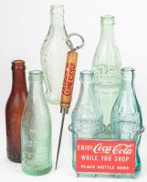 Coca-Cola: Six Bottles of Various Ages and Shopping Cart Bottle Holder