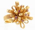 Lady's 14K Yellow Gold and Ruby Cocktail Ring in a Delightful Brushed Ribbon Bow Design