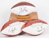 Three Signed Footballs: Carson Palmer, Teyo Johnson and Justin Vargas and one Display all on Official Wilson NFL Footballs