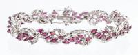 Lady's 14K White Gold and 3 Carats of Marquis Shaped Rubies in a Floral Motif Accented with Diamonds.