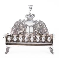 Antique 800 Silver Menorah with Urn Shaped Oil Pots Along Bench that Sits in a Cradle with Exceptional High Repousse Details