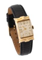 The Gentleman's Classic Bulova 14k Yellow Gold Watch with Double Curved Lugs and Sleek Genuine Lizard Watchband