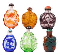 Collection of Five (5) Very Appealing Carved Peking Glass Overlay Snuff Bottles and One in Carved Brown Glass