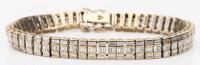 Vintage Tennis Style Bracelet in 18K White Gold with Approx. 5 Carats of Baguette Cut Diamonds.