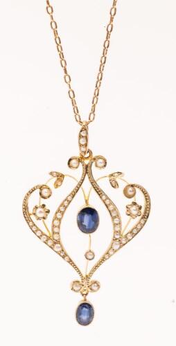 Lovely Victorian Revival Pendant in 14K Yellow Gold with Two Fine Sapphires and Seed Pearls in a Delicate Floral Motif.