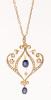 Lovely Victorian Revival Pendant in 14K Yellow Gold with Two Fine Sapphires and Seed Pearls in a Delicate Floral Motif.