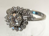 Lovely Engagement Ring Having a Fine Center Diamond .60 Carats, Surrounded in a Swirl of Accent Diamonds in 14K White Go