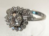 Lovely Engagement Ring Having a Fine Center Diamond .60 Carats, Surrounded in a Swirl of Accent Diamonds in 14K White Go