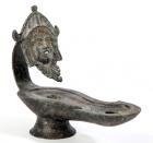 ROMAN. Bronze footed oil lamp with theater mask decorating terminus of handle