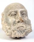 ROMAN(?). Marble head of grotesque male, bald and bearded, with slightly protruding tongue