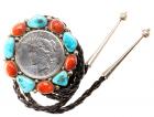 A bolo tie with a 1926 Peace Dollar encircled by turquoise and carnelian stones all atop sterling silver